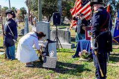 Auxiliary President Vali Reyes Places a Rose at the Grave
