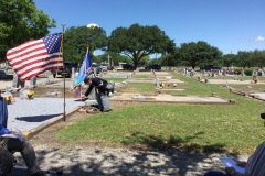 Lance-placing-small-flag-at-grave