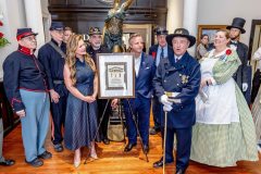 Daniel Pourreau presenting a Certificate of Recognition to hosts Shaun and Natalie Hodge.